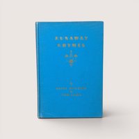 An antique bright blue cloth hardcover book with gold gilt text and a small candle emblem on the front cover