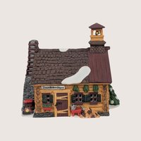 Department 56 Sleepy Hollow School ceramic log cabin schoolhouse with a bell tower and stone chimney.