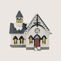 Department 56 Church of the Open Door ceramic building with white clapboard siding and a dark shingled roof spire.