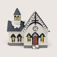 Department 56 Church of the Open Door ceramic building with white clapboard siding and a dark shingled roof spire.