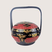 A vintage Chinese hand painted bamboo wedding basket with a black and red lacquer finish.