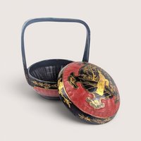 A vintage Chinese hand painted bamboo wedding basket with a black and red lacquer finish.