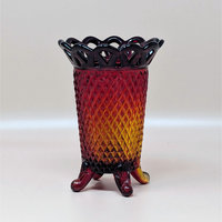 A vintage Imperial Glass Amberina vase (C3319 1.jpg) with a diamond point texture and a lace-cut reticulated rim. The glass transitions from ruby red at the top to golden amber at the base, standing on three small feet.
