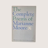 A vintage 1967 hardcover edition of The Complete Poems of Marianne Moore with blue and green typography on a gray dust jacket.