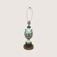 A vintage Italian ceramic table lamp featuring a green and white ornate urn body painted with cherubs.