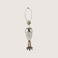 A vintage Hollywood Regency table lamp with a cut glass urn body and hanging crystal glass prisms.