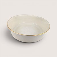 Round ceramic serving bowl with a white floral medallion design on the interior and a gold rim, centered on a plain linen background.