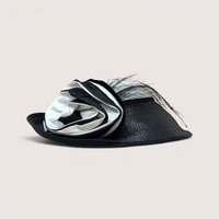 A vintage Jody G for Sylvia black and white straw hat featuring a large matching fabric rosette on the side.