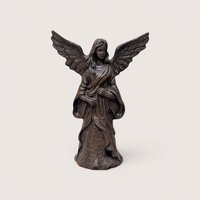 Bronze-finished angel figurine with outspread wings and a patterned gown, centered on a plain linen background.