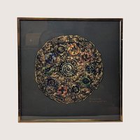 A framed 1997 mixed media painting by Barbara DeVault titled Decadisk featuring a textured circular paper medallion.