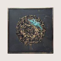 A framed 1997 mixed media painting by Barbara DeVault titled Lizard Disk featuring a textured paper medallion with a blue lizard.