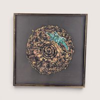 A framed 1997 mixed media painting by Barbara DeVault titled Lizard Disk featuring a textured paper medallion with a blue lizard.