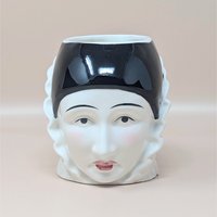 A vintage Sigma Taste Setter ceramic mug shaped like a Pierrot clown face, featuring a glossy black cap, ruffled collar, and hand-painted facial details on a neutral background.