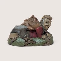 1996 Tom Clark signed Turtle gnome figurine crawling with a leather backpack on a linen background