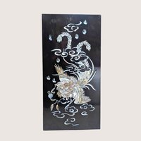 Vintage Asian black lacquer wood wall panel with iridescent mother of pearl inlay depicting a phoenix among clouds on a linen background