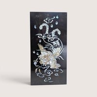 Vintage Asian black lacquer wood wall panel with iridescent mother of pearl inlay depicting a phoenix among clouds on a linen background