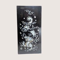 Vintage Asian black lacquer wood wall panel with iridescent mother of pearl inlay depicting a dragon among clouds on a linen background