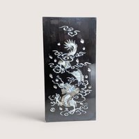 Vintage Asian black lacquer wood wall panel with iridescent mother of pearl inlay depicting a dragon among clouds on a linen background