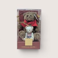Lenox 100th Anniversary American Bears set with a brown plush teddy bear cradling a white patriotic porcelain ornament.