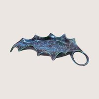 Vintage mid century handmade ceramic holly leaf dish featuring a striking blue and purple reactive drip glaze with an integrated loop handle.
