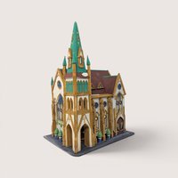 A handpainted porcelain Dept 56 All Saints Corner Church building on a linen background