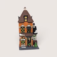 A handpainted porcelain Dept 56 Potters Tea Seller building on a linen background