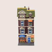 A handpainted porcelain Dept 56 5609 Park Ave Townhouse building on a linen background