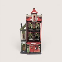 A vintage porcelain Christmas village building featuring a brick Chinese restaurant and a stone laundry shop on a beige backdrop
