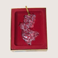 Clear crystal angel Christmas ornament holding a star inside its original gold and red velvet box.