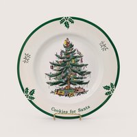 A round cream holiday plate featuring a central decorated Christmas tree design and green border on a plain background