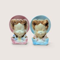 Pair of 1950s Royal Copley ceramic lady head wall pocket planters in pastel pink and blue bonnets.