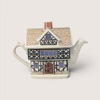 A vintage Sadler ceramic teapot shaped like a two-story English Tudor house with half-timbered architectural details.