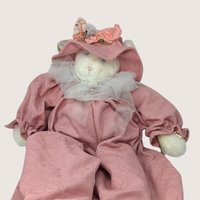 Vintage large artisan fabric cat plush doll named Jolie in a pink bonnet and romper outfit.