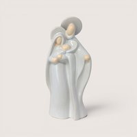 A minimalist light blue and cream ceramic figurine of Mary Joseph and baby Jesus on a solid plain background