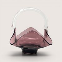 Amethyst art glass basket with a ruffled handkerchief edge and a clear glass arched handle on a solid background.