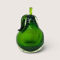 Green hand blown glass pear paperweight with a clear bullicante bubble pattern and applied stem on a solid background.