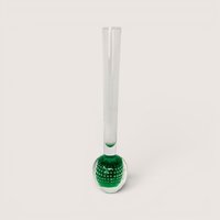Slender clear glass bud vase with a heavy green bulbous base containing a controlled bubble pattern on a solid background.