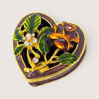 Heart shaped trinket box featuring enameled purple surfaces topped with gold metallic floral vines and clear rhinestones.