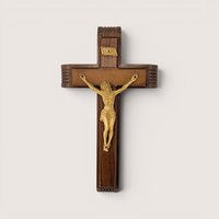 A vintage wooden wall crucifix shadow box with a corpus figure on a plain light background