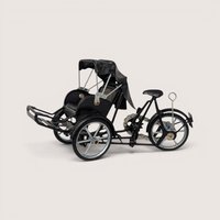 A miniature black metal model of a traditional Vietnamese cyclo rickshaw with silver wheels on a plain background