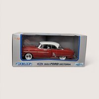 A red 1953 Ford Victoria toy car with a white roof sealed inside its original gray and blue Welly box
