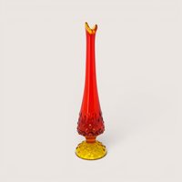 A vintage swung glass vase with a hobnail texture transitioning from a yellow base to a vibrant red pulled neck.