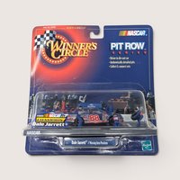 A vintage sealed NASCAR toy package featuring a Dale Jarrett pit stop diorama with a miniature race car and crew figures