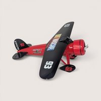 A red and black Racing Champions 1929 Travel Air Model R NASCAR die-cast airplane bank on a light background