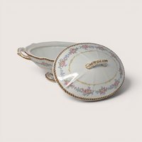 Elite Works Limoges porcelain covered bowl with pink and blue floral swags and gold trim on a white background.