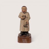 Vintage Anri Toriart hand-carved wood figurine of an old-world apothecary pharmacist holding a mortar and pestle.