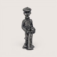Miniature vintage pewter figurine of a male golfer wearing a flat cap and sweater leaning on his golf bag.
