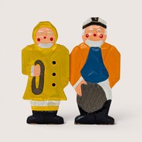 Two vintage handpainted wooden folk art sailor figures including a captain in orange and a fisherman in a yellow raincoat.