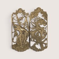 Vintage pierced brass rectangular openwork wall plaques featuring a stylized tiger in bamboo and a detailed dragon.