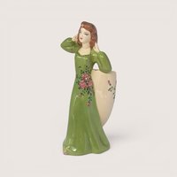 Vintage ceramic lady head vase and figurine in a green dress holding a floral planter.